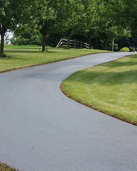 HawkSeale-treated millings driveway curving through a lawn